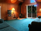 cabin living room with views and wood stove.